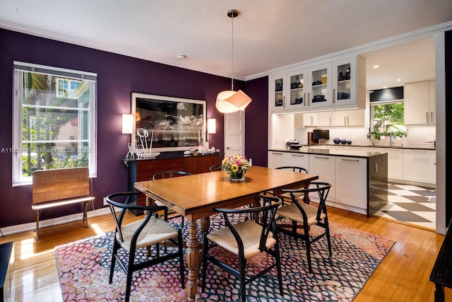 3245 Riviera Dr, Coral Gables, FL 33134 - dining space featuring light wood-style floors and ornamental molding