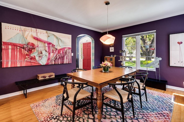3245 Riviera Dr, Coral Gables, FL 33134 - dining area featuring arched walkways, wood finished floors, baseboards, and ornamental molding