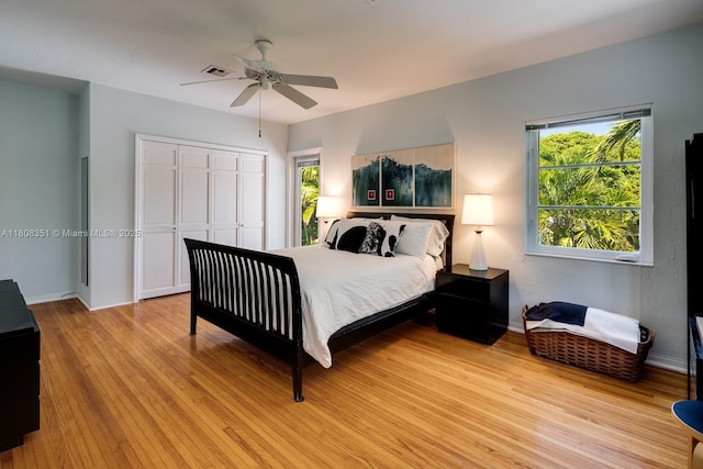 3245 Riviera Dr, Coral Gables, FL 33134 - bedroom with light wood finished floors, a closet, ceiling fan, and baseboards
