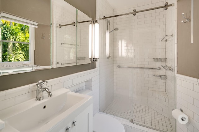 3245 Riviera Dr, Coral Gables, FL 33134 - bathroom with a stall shower, tile walls, vanity, and toilet