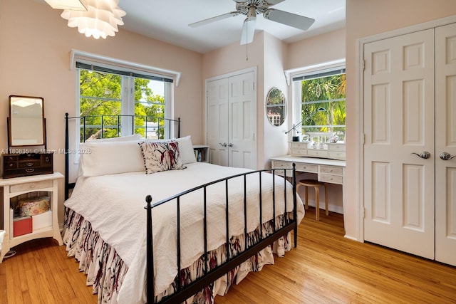 3245 Riviera Dr, Coral Gables, FL 33134 - bedroom with two closets, light wood-type flooring, and ceiling fan