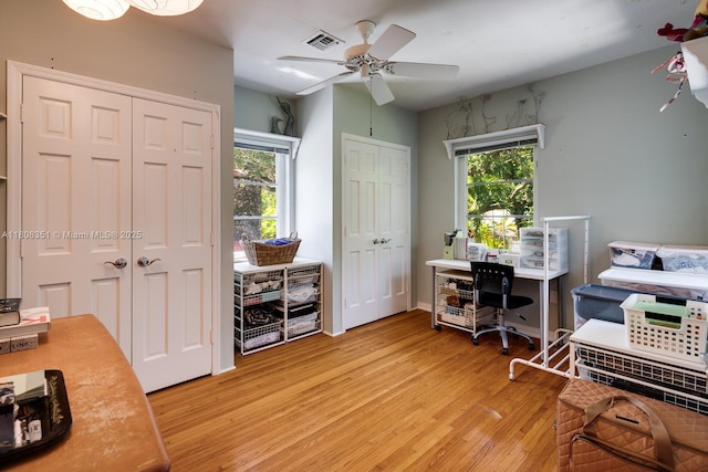 3245 Riviera Dr, Coral Gables, FL 33134 - home office with light wood-style flooring and a ceiling fan