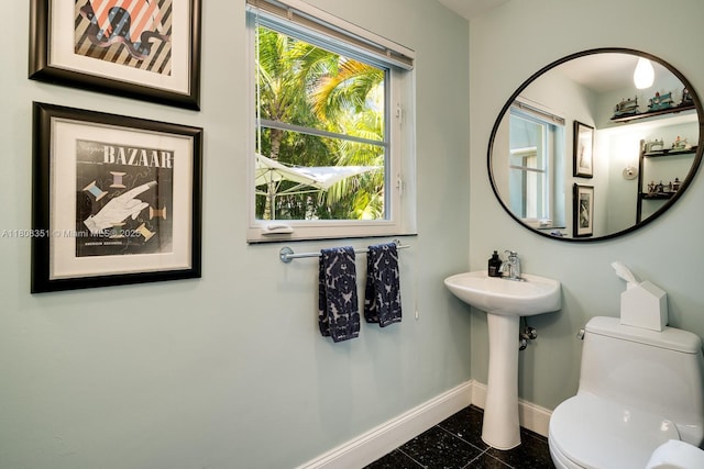 3245 Riviera Dr, Coral Gables, FL 33134 - bathroom featuring baseboards, toilet, and a sink