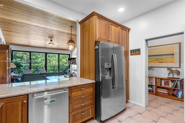 101 Ocean Lane Dr Unit 4012, Key Biscayne, FL 33149 - kitchen with stainless steel appliances, light stone countertops, brown cabinetry, recessed lighting, and baseboards