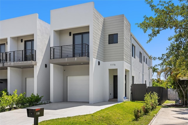 1116 NE 10th Ave, Fort Lauderdale, FL 33304 - contemporary home featuring an attached garage, stucco siding, concrete driveway, and a balcony