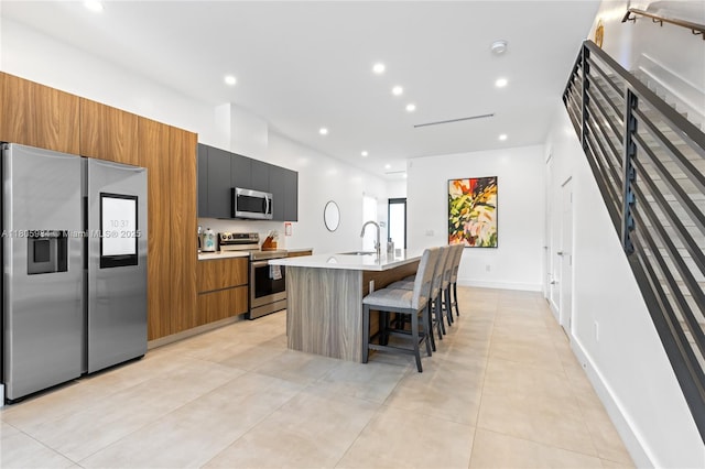 1116 NE 10th Ave, Fort Lauderdale, FL 33304 - kitchen with stainless steel appliances, a sink, modern cabinets, a center island with sink, and a kitchen bar