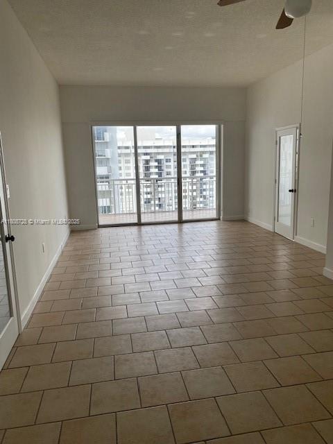 18061 Biscayne Blvd Unit Ph02, Aventura, FL 33160 - empty room with ceiling fan and baseboards