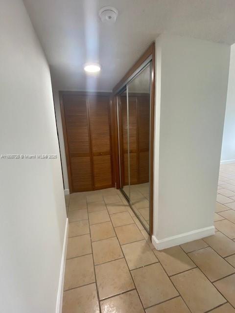 18061 Biscayne Blvd Unit Ph02, Aventura, FL 33160 - hallway with light tile patterned floors and baseboards
