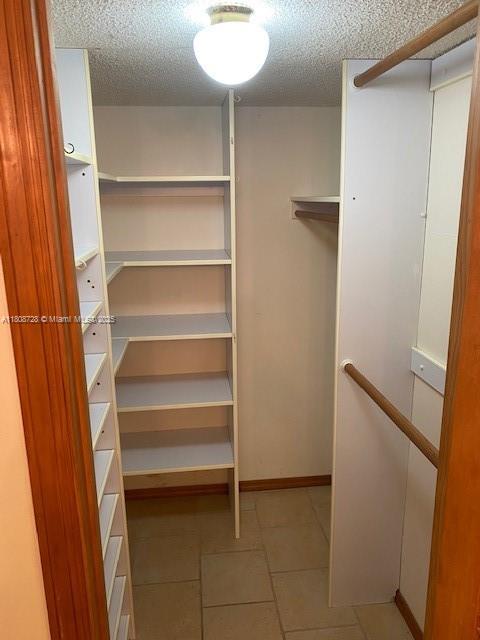 18061 Biscayne Blvd Unit Ph02, Aventura, FL 33160 - walk in closet with tile patterned flooring
