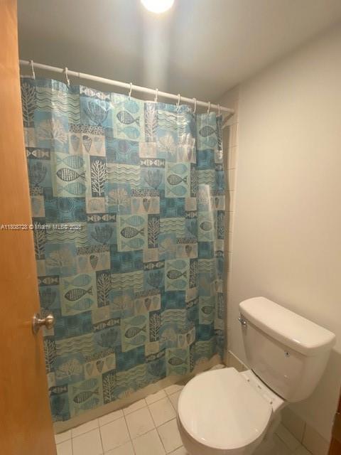 18061 Biscayne Blvd Unit Ph02, Aventura, FL 33160 - full bath with tile patterned floors and a shower with shower curtain