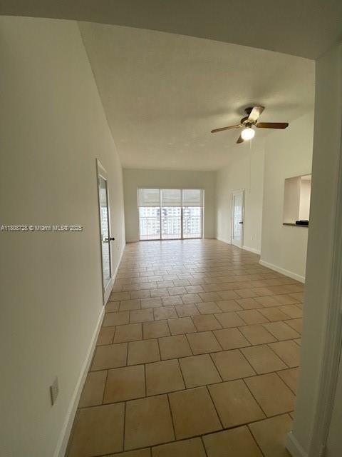 18061 Biscayne Blvd Unit Ph02, Aventura, FL 33160 - tiled empty room with ceiling fan and baseboards
