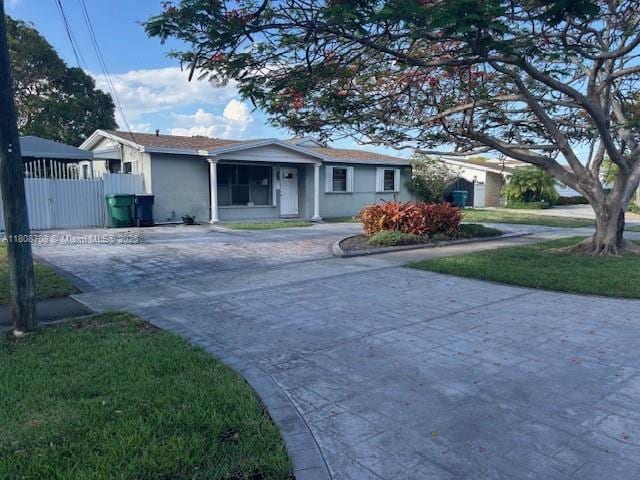 9301 SW 16th St, Miami, FL 33165 - single story home with concrete driveway and stucco siding