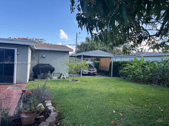 9301 SW 16th St, Miami, FL 33165 - view of grassy yard featuring a carport