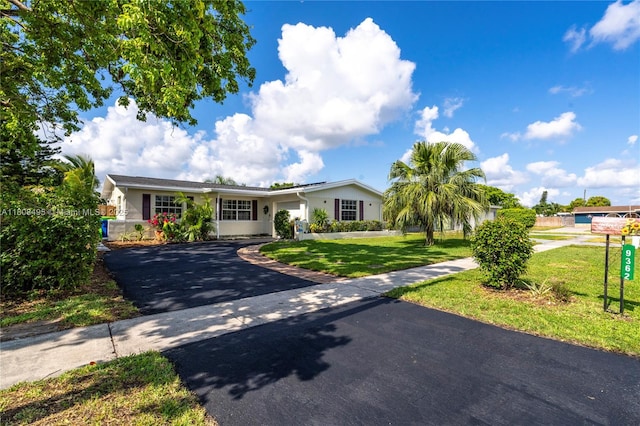9362 NW 24th Pl, Sunrise, FL 33322 - single story home featuring driveway, a front yard, and stucco siding