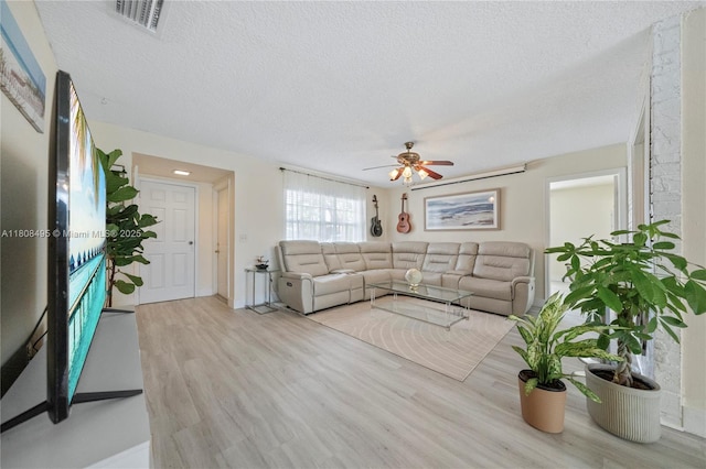 9362 NW 24th Pl, Sunrise, FL 33322 - living area with a textured ceiling, wood finished floors, and a ceiling fan