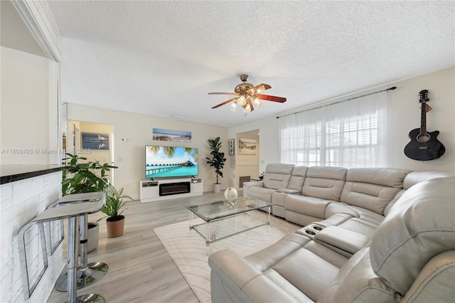 9362 NW 24th Pl, Sunrise, FL 33322 - living area with a textured ceiling, ceiling fan, and light wood finished floors