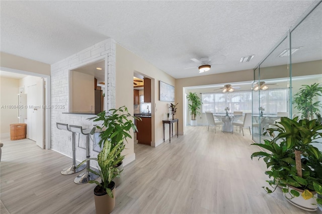 9362 NW 24th Pl, Sunrise, FL 33322 - corridor featuring light wood-style flooring and a textured ceiling
