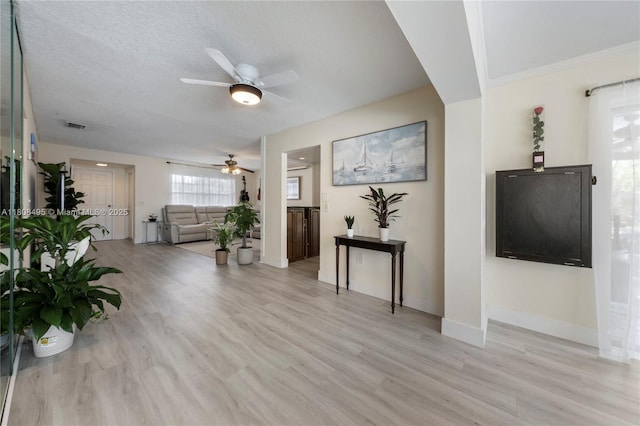 9362 NW 24th Pl, Sunrise, FL 33322 - living room with a ceiling fan, light wood-type flooring, baseboards, and a textured ceiling