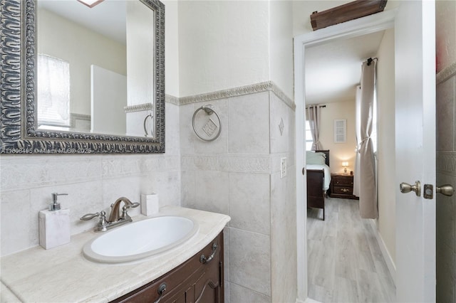 9362 NW 24th Pl, Sunrise, FL 33322 - ensuite bathroom with tile walls, vanity, and wood finished floors