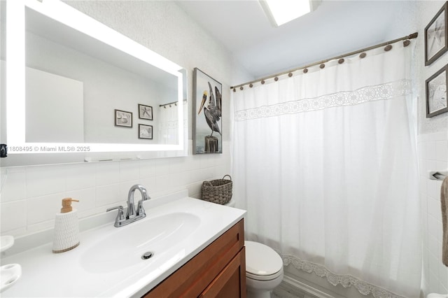 9362 NW 24th Pl, Sunrise, FL 33322 - bathroom featuring toilet, vanity, tile walls, shower / tub combo with curtain, and tasteful backsplash