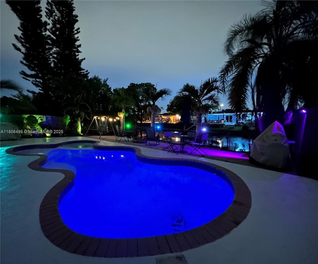 9362 NW 24th Pl, Sunrise, FL 33322 - pool at dusk with an outdoor pool and a patio area