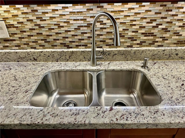 10760 Hickory Ave, Pembroke Pines, FL 33026 - kitchen view of a sink, tasteful backsplash, and light stone counters