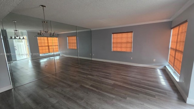 11890 SW 18th Ter Unit 112, Miami, FL 33175 - unfurnished living room featuring a textured ceiling, plenty of natural light, ornamental molding, wood finished floors, and baseboards
