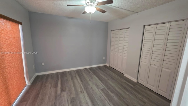 11890 SW 18th Ter Unit 112, Miami, FL 33175 - unfurnished bedroom featuring multiple closets, a textured ceiling, dark wood-type flooring, ceiling fan, and baseboards