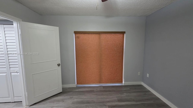 11890 SW 18th Ter Unit 112, Miami, FL 33175 - unfurnished bedroom with wood finished floors, a textured ceiling, and baseboards