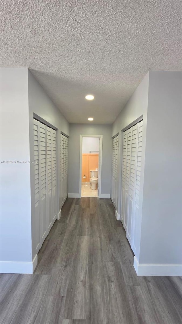 11890 SW 18th Ter Unit 112, Miami, FL 33175 - corridor featuring wood finished floors, baseboards, a textured ceiling, and recessed lighting