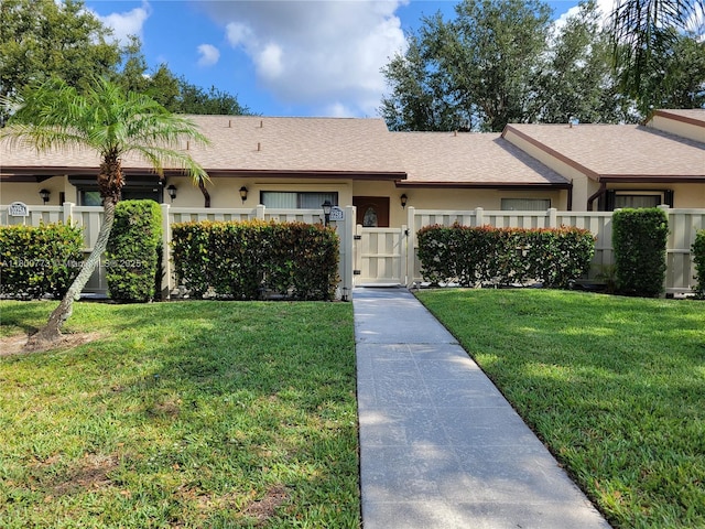 1025 Green Pine Blvd Unit B, West Palm Beach, FL 33409 - single story home featuring stucco siding, a shingled roof, and a gate