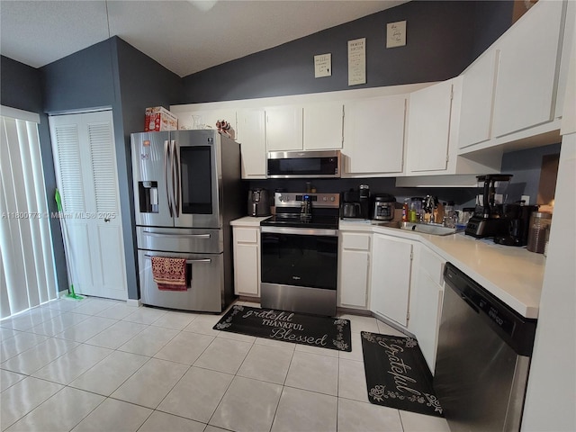 1025 Green Pine Blvd Unit B, West Palm Beach, FL 33409 - kitchen featuring appliances with stainless steel finishes, light countertops, white cabinetry, and light tile patterned floors