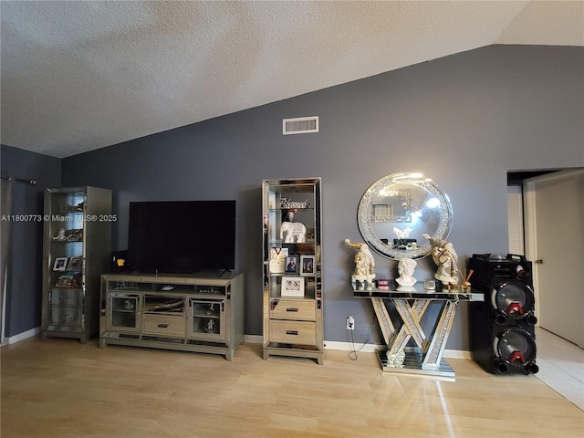 1025 Green Pine Blvd Unit B, West Palm Beach, FL 33409 - living area featuring vaulted ceiling, wood finished floors, and baseboards