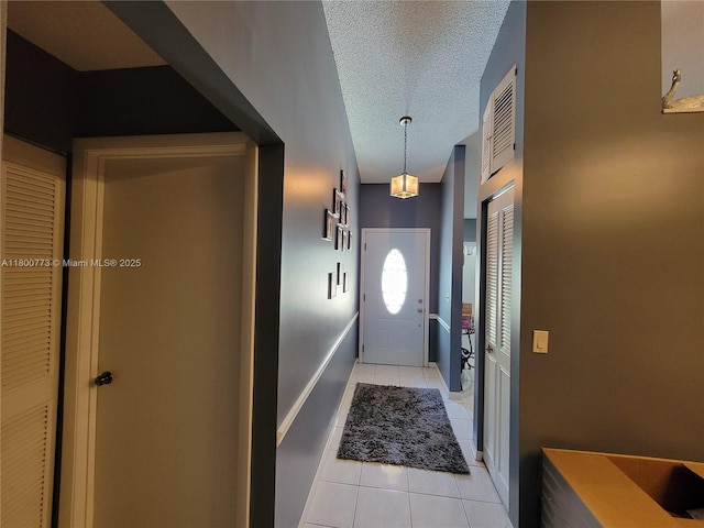 1025 Green Pine Blvd Unit B, West Palm Beach, FL 33409 - entryway with light tile patterned floors and a textured ceiling