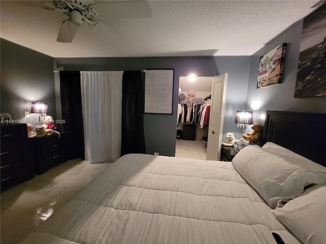 1025 Green Pine Blvd Unit B, West Palm Beach, FL 33409 - bedroom with light marble finish flooring, ceiling fan, a textured ceiling, a walk in closet, and a closet
