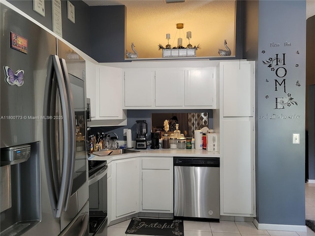 1025 Green Pine Blvd Unit B, West Palm Beach, FL 33409 - kitchen featuring appliances with stainless steel finishes, a sink, light countertops, and light tile patterned floors