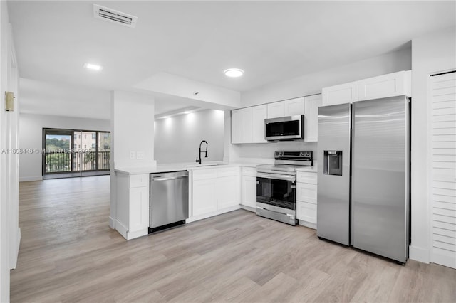 14475 Strathmore Ln Unit 305, Delray Beach, FL 33446 - kitchen featuring appliances with stainless steel finishes, light countertops, a sink, and white cabinetry