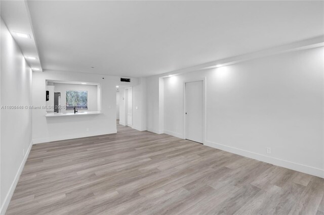 14475 Strathmore Ln Unit 305, Delray Beach, FL 33446 - unfurnished room with wood finished floors, baseboards, and a sink