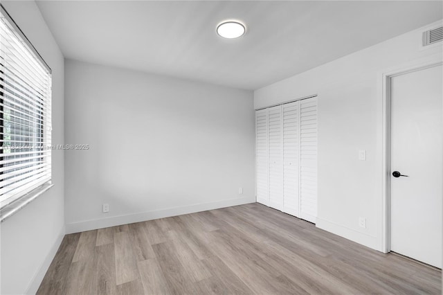 14475 Strathmore Ln Unit 305, Delray Beach, FL 33446 - unfurnished bedroom with wood finished floors, a closet, and baseboards