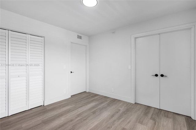 14475 Strathmore Ln Unit 305, Delray Beach, FL 33446 - unfurnished bedroom featuring wood finished floors