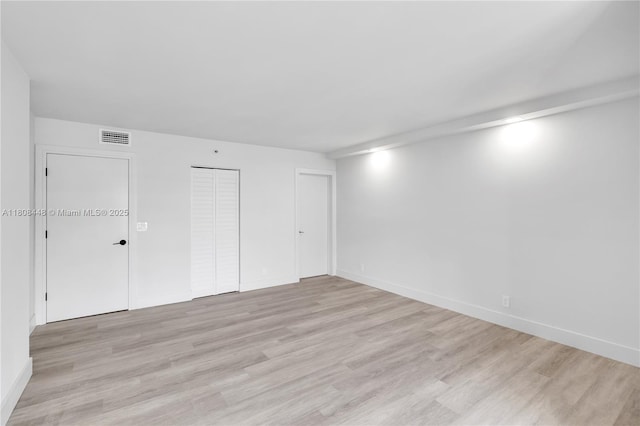 14475 Strathmore Ln Unit 305, Delray Beach, FL 33446 - unfurnished bedroom featuring light wood-style floors, a closet, and baseboards