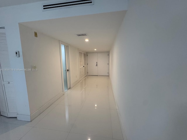 6423 Collins Ave Unit 1001, Miami Beach, FL 33141 - hallway featuring baseboards, light tile patterned floors, and recessed lighting