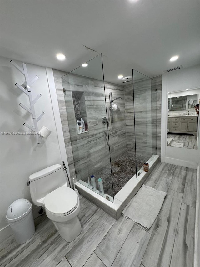 6423 Collins Ave Unit 1001, Miami Beach, FL 33141 - full bath with toilet, wood tiled floors, a shower stall, vanity, and recessed lighting