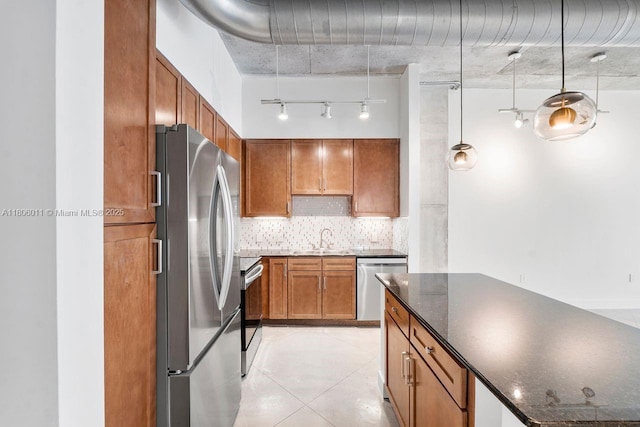 2001 Biscayne Blvd Unit 2308, Miami, FL 33137 - kitchen with stainless steel appliances, a sink, tasteful backsplash, brown cabinets, and light tile patterned floors