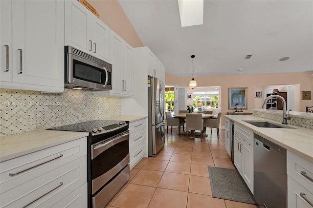 2215 SW 14th Pl, Boca Raton, FL 33486 - kitchen featuring stainless steel appliances, tasteful backsplash, light tile patterned floors, and white cabinets