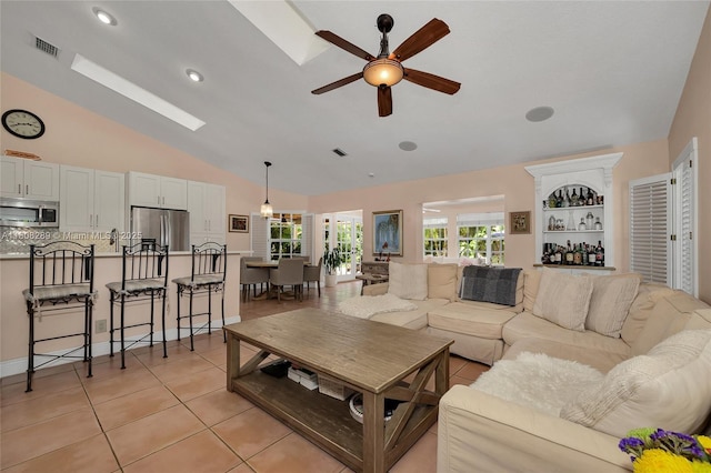 2215 SW 14th Pl, Boca Raton, FL 33486 - living area featuring vaulted ceiling, ceiling fan, light tile patterned floors, and a skylight