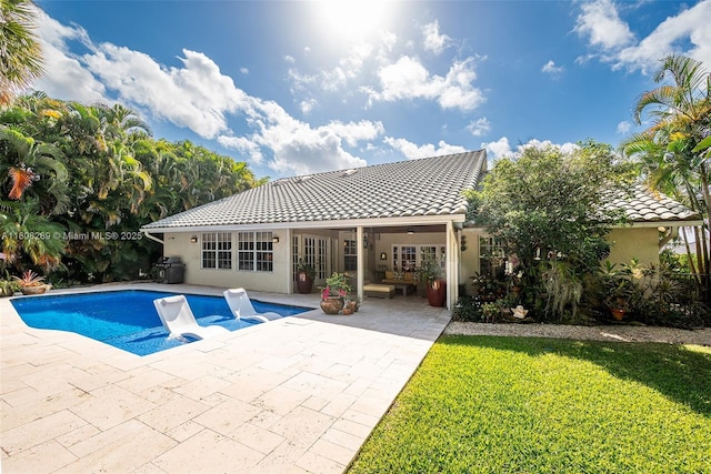 2215 SW 14th Pl, Boca Raton, FL 33486 - swimming pool with a patio, a lawn, and french doors