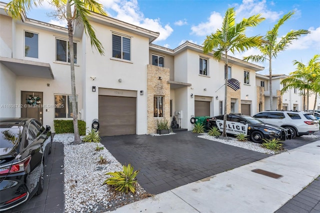 17612 SW 153rd Ave, Miami, FL 33187 - townhome / multi-family property with stucco siding, a garage, decorative driveway, and a residential view