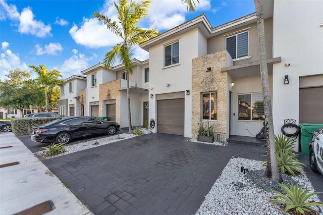 17612 SW 153rd Ave, Miami, FL 33187 - multi unit property with stucco siding, decorative driveway, an attached garage, and a residential view