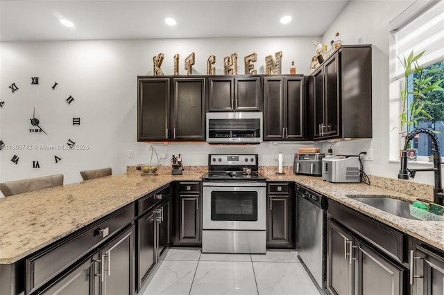 17612 SW 153rd Ave, Miami, FL 33187 - kitchen featuring stainless steel appliances, a sink, light marble finish floors, a peninsula, and light stone countertops